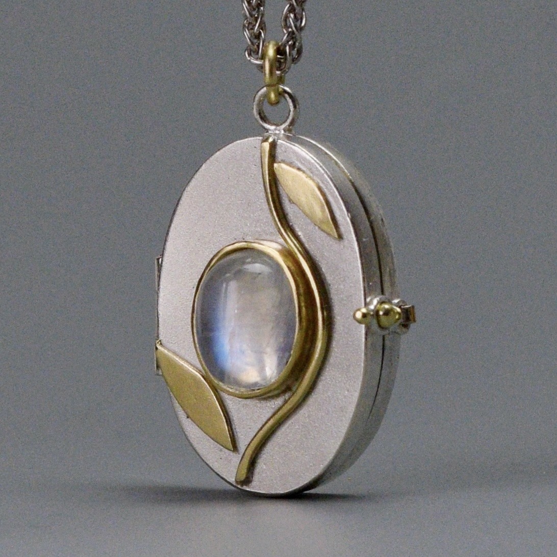 silver, gold, and white charm