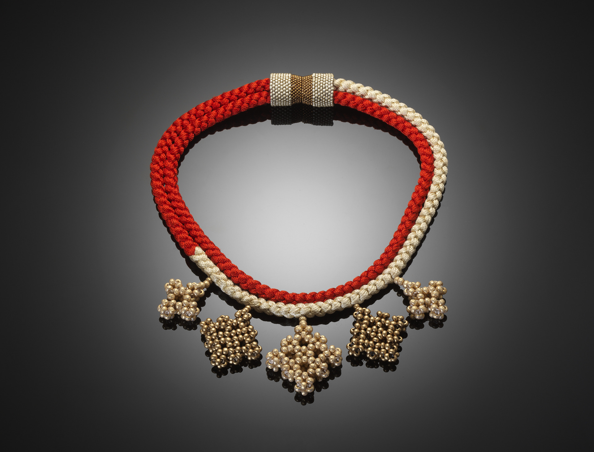 red, ivory, and gold jewelry