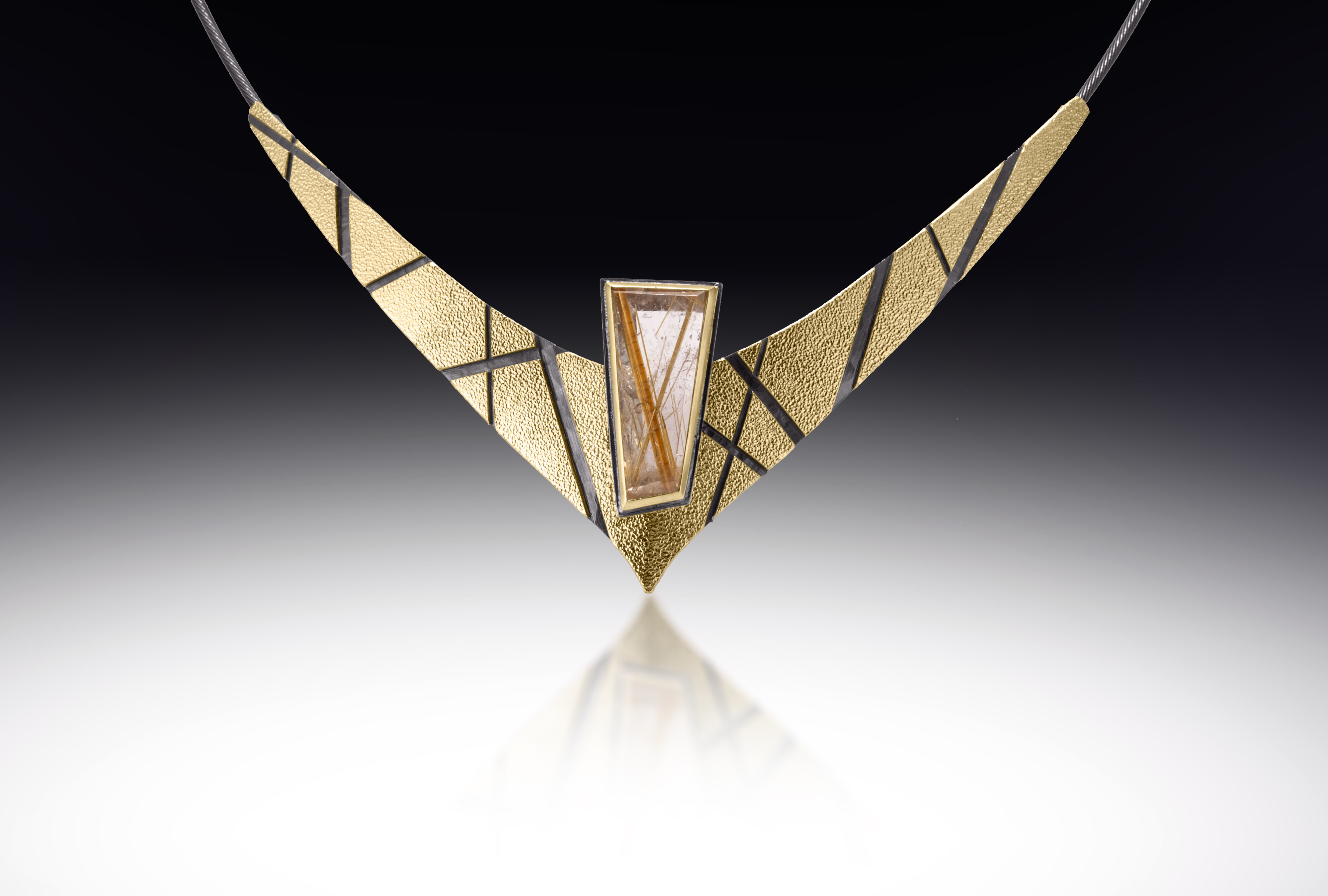 gold and black necklace