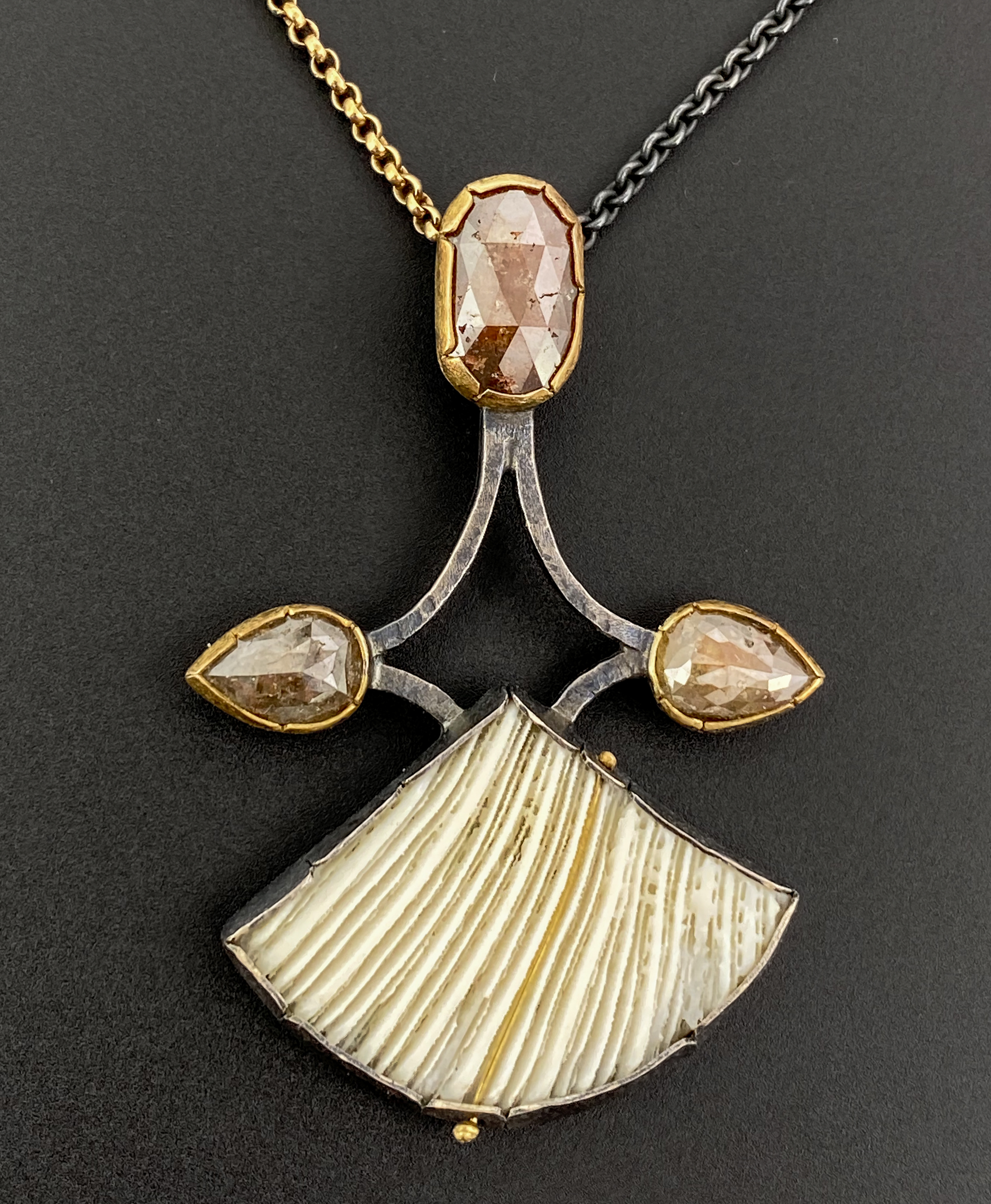 silver, gold, and ivory charm