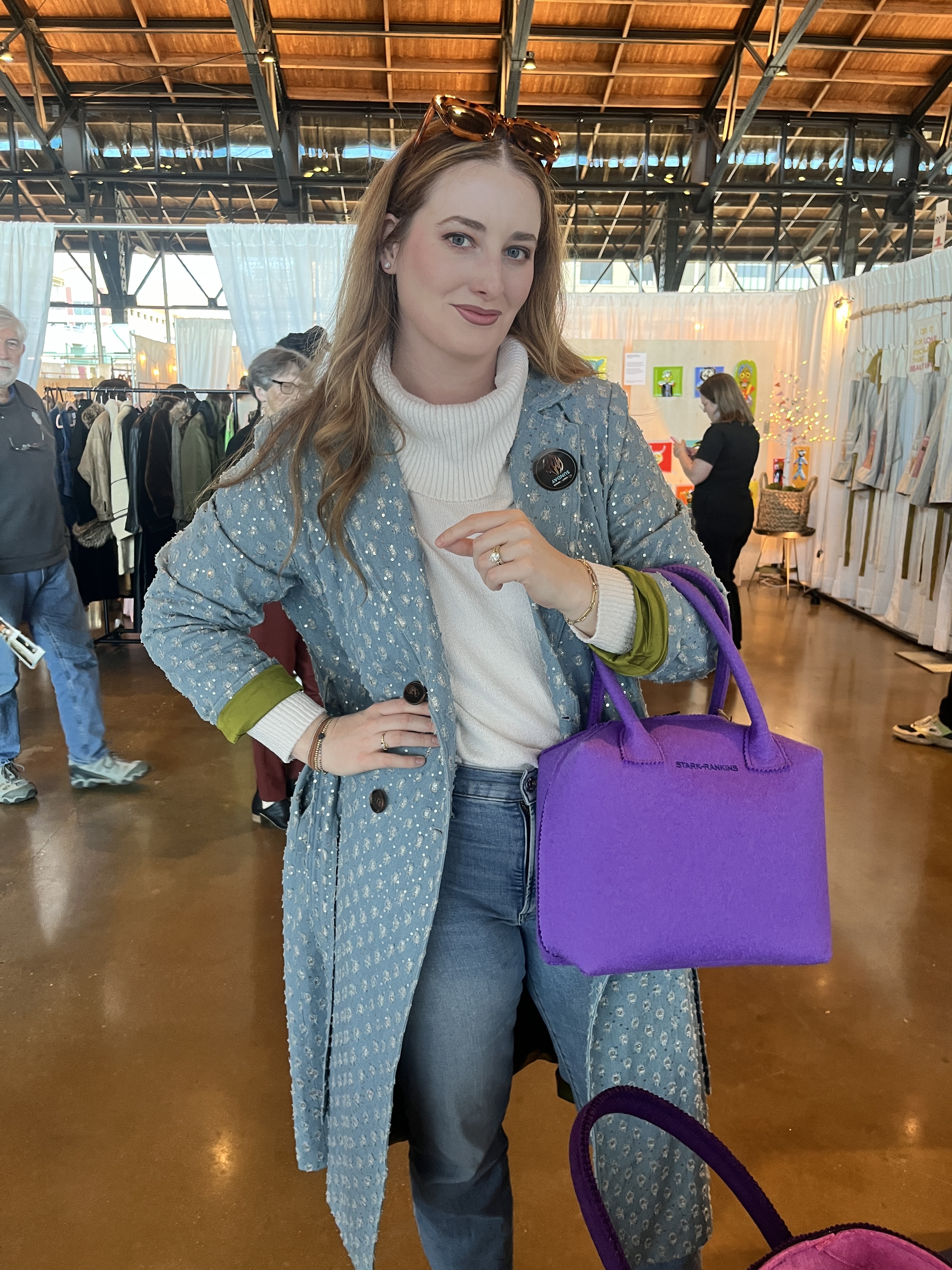 model holding purple felt bag