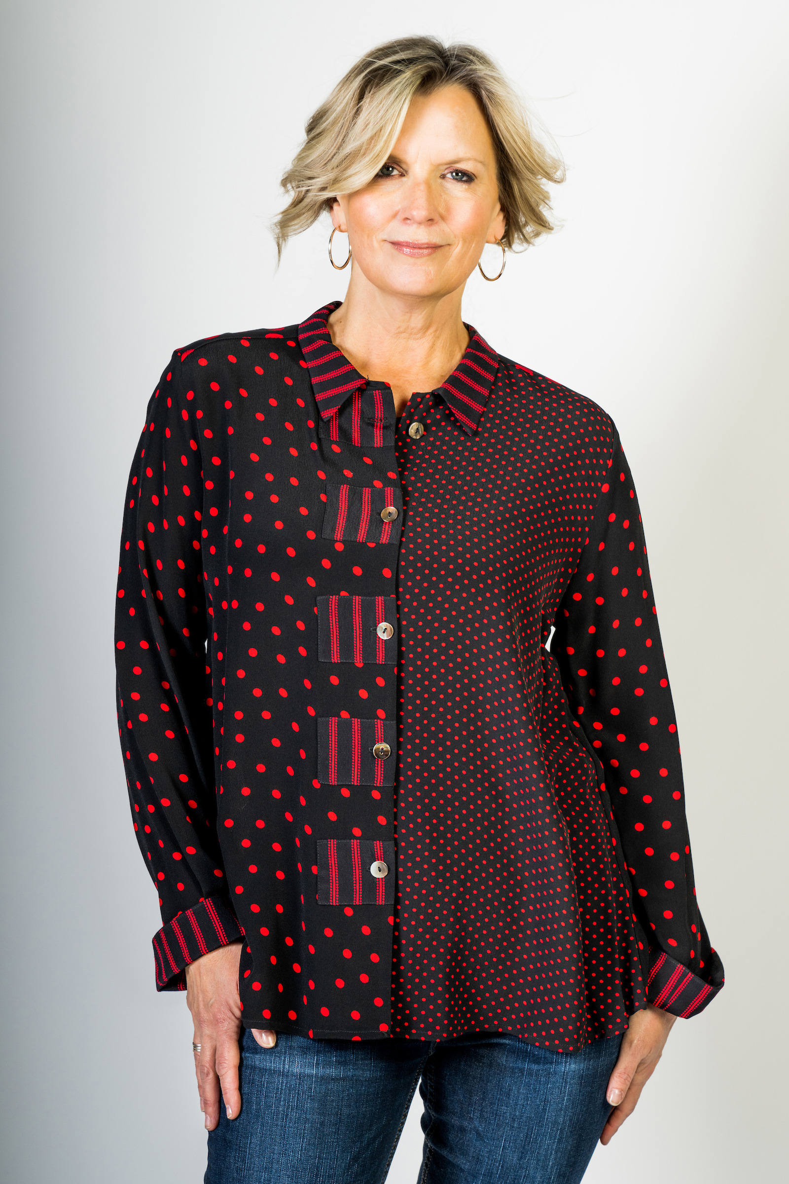 model with asymmetric shirt with polka dots and stripes
