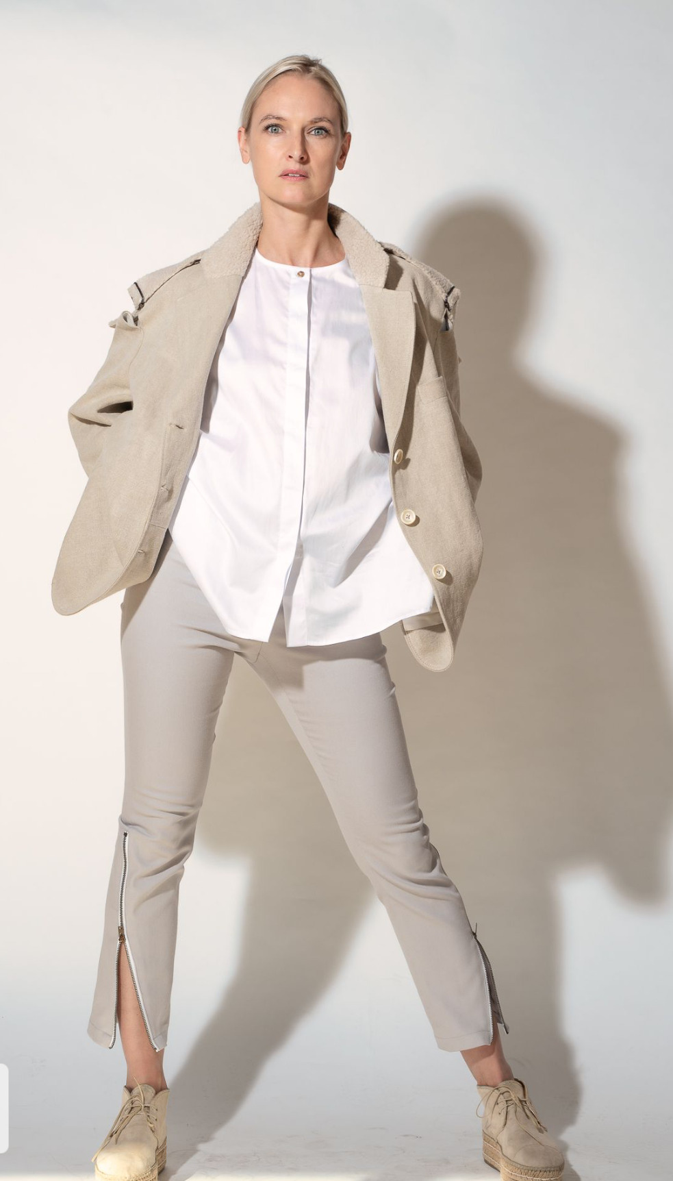 Model with suit, pants have zippers up to the knee