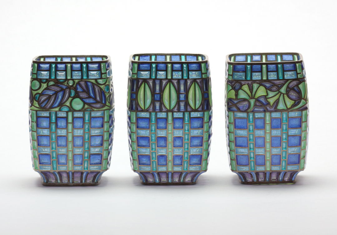 Materials: Enamel  sterling silver. Technique: Plique a Jour-- I construct a sterling framework  then fill openings with enamel powders and fire in furnace until it fuses to the silver. This is repeated until the openings are filled. Surface tension keeps the molten glass in place during firing.