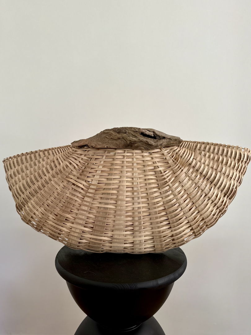 Hald-circle shaped basket with light wood weave and dark driftwood rim