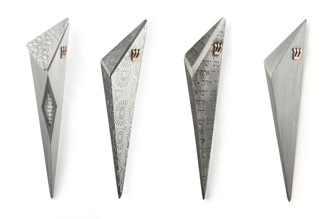 An abstract design for a more contemporary taste.These Mezuzahs have been made from fabricated pewter with copper shins.