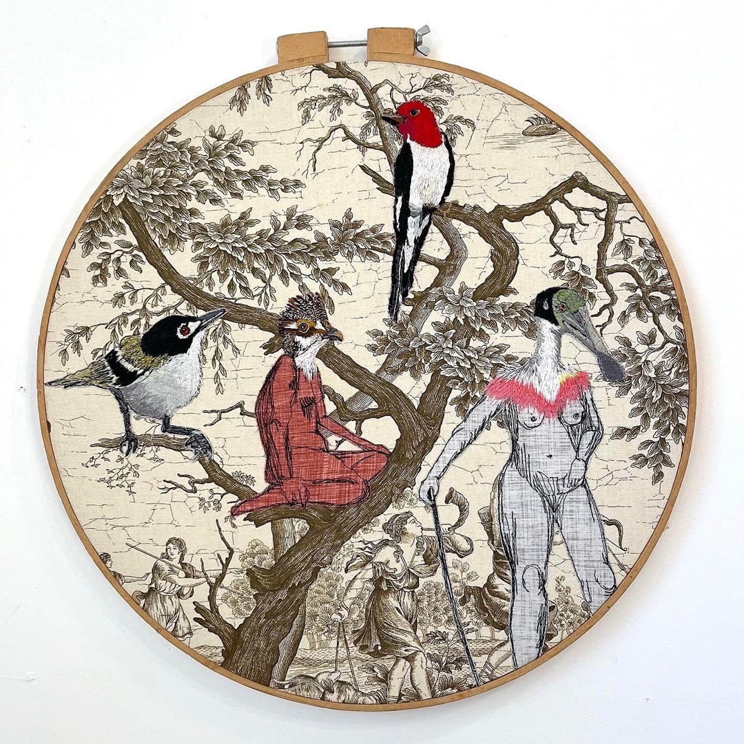 embroidered bird people and birds on  vintage toile decor fabric.