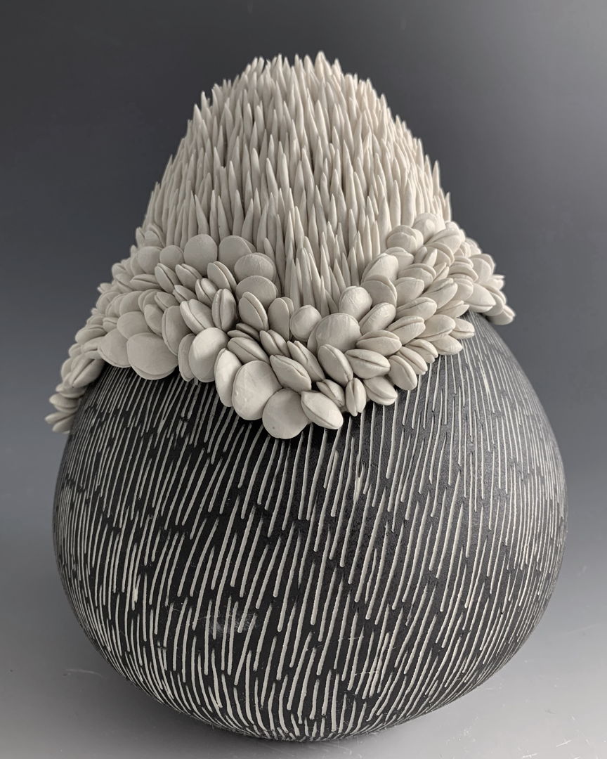 Made from porcelain on the wheel  motifs are handmade  underglazed  hand carved  fired to high/medium fire.