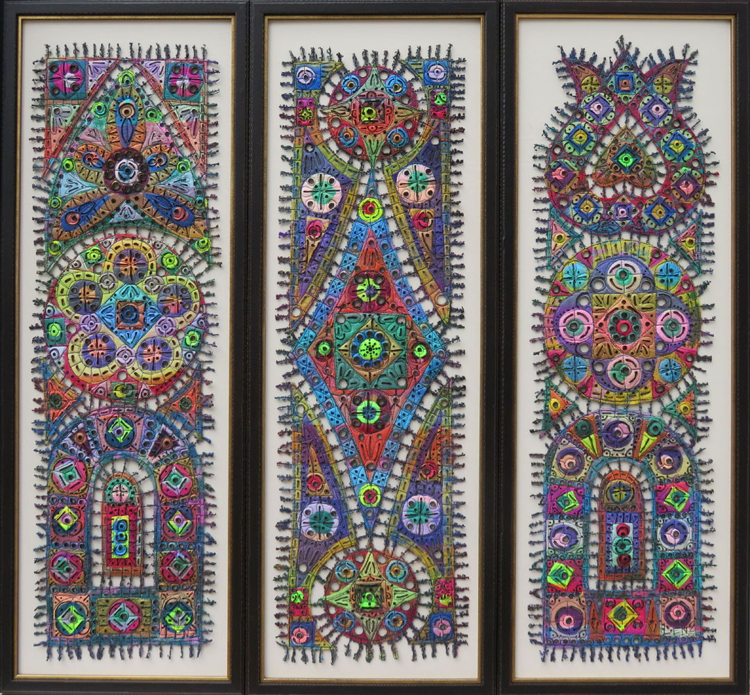 Three verticle rectangular framed pieces made up of colorful pieces connected and embellished with thread