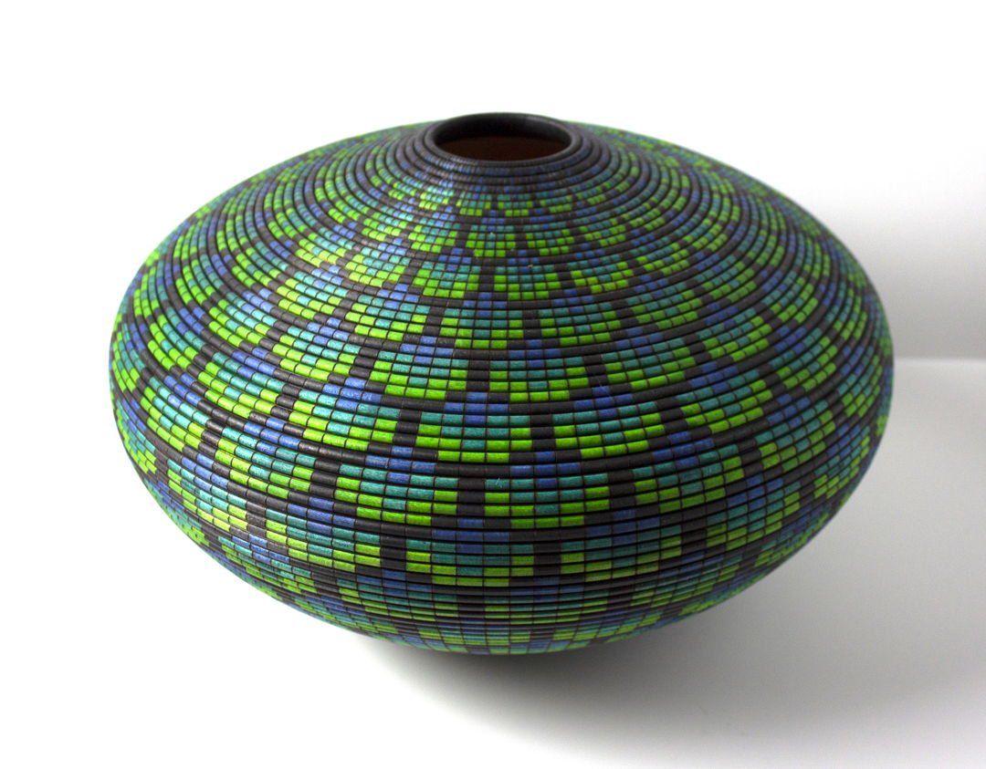 Turned and hollowed Maple vessel embellished with pyrography and hand-dyed with archival ink to give the appearance of a woven basket.