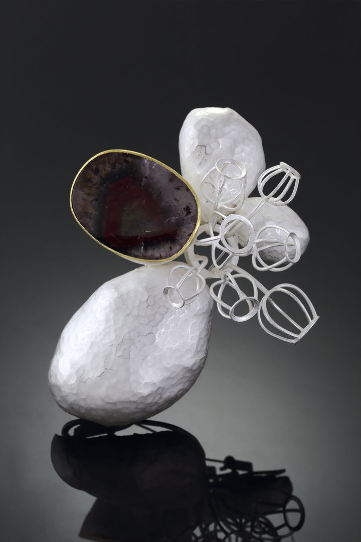 This brooch depicts a scenery of flower buddings growing through the rocks. I used a fancy quartz to indicate a rock  broken in half  showing it's colorful beauty inside. 22k gold  sterling silver  Quartz.