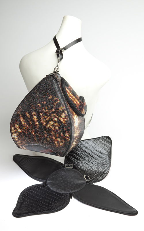 Blossom pattern zips into Pear; closed; recycled vinyl billboard with conveyor belting cutoffs strap. Shown open in leather. A transforming marvel suitable for entertaining your friends.