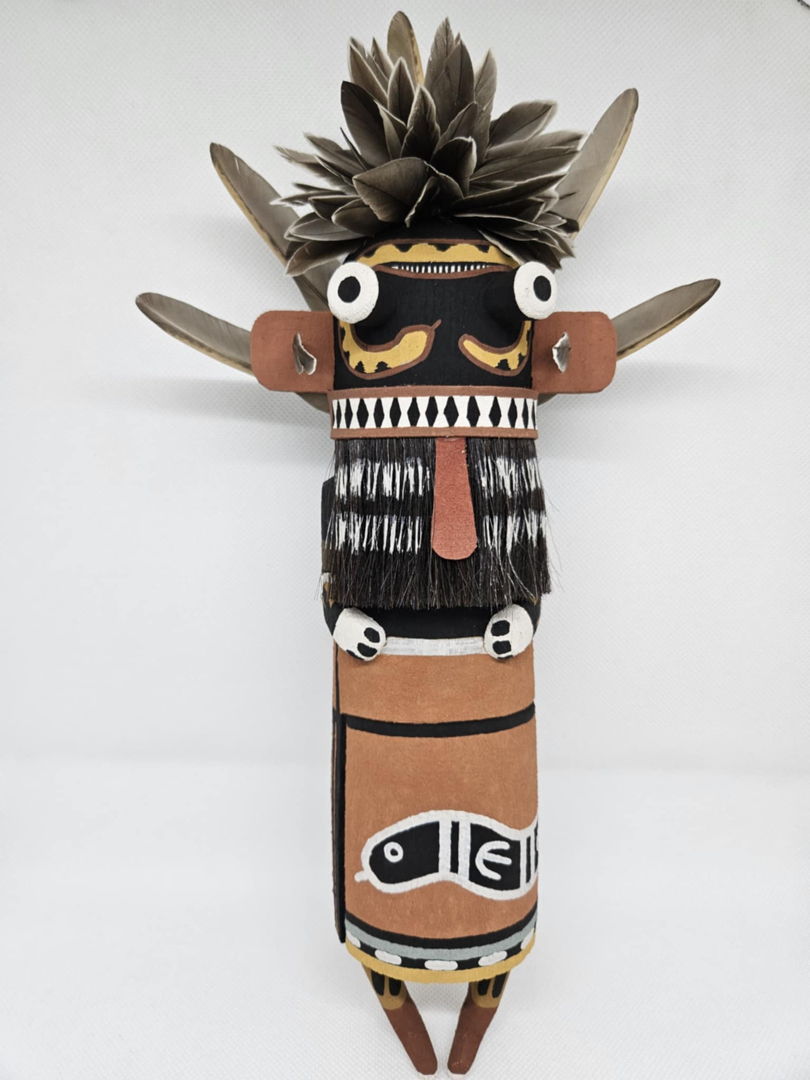 The Snake Kachina is a guard and protector  he is often seen during the summer kachina dances. The Kachina is carved out of aged cottonwood root  painted with natural earth mineral paints that I hand collect and process myself. Duck feathers  quail feathers and yucca from the yucca plant add to the finishing touches.