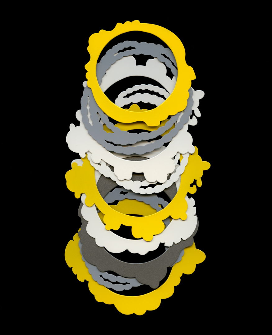 Bangle bracelets hand-pierced from 18g brass and powder coated various colors. Bracelet designs inspired by images and common motifs found in historical jewelry.