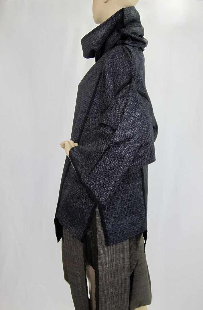 Oshima Tsumugi is a high-quality fabric that is 100% silk  plant-dyed  and hand-woven. The top is dyed with real indigo. The skirt is mud-dyed. In order to preserve the beauty of the fabric  I incorporated the hand weaving into the design  which is visible on the edge of the cloth.