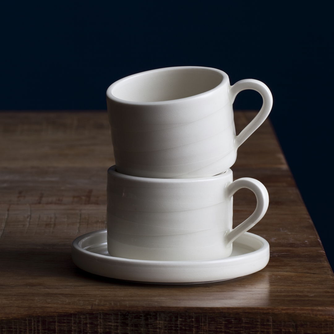 two stacked coffee cups with subtle line suggesting a hand-throwing process