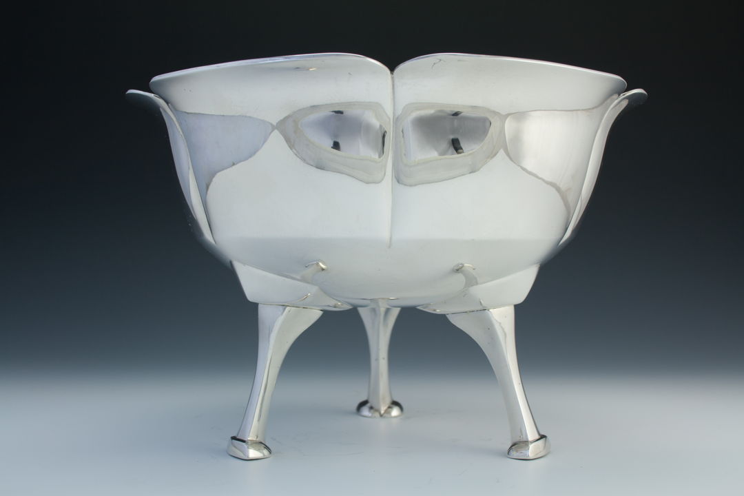 The bowl of this piece was hammered out of single large ingot of hand-poured silver and then raised into form. The long elegant legs were sandcast individually