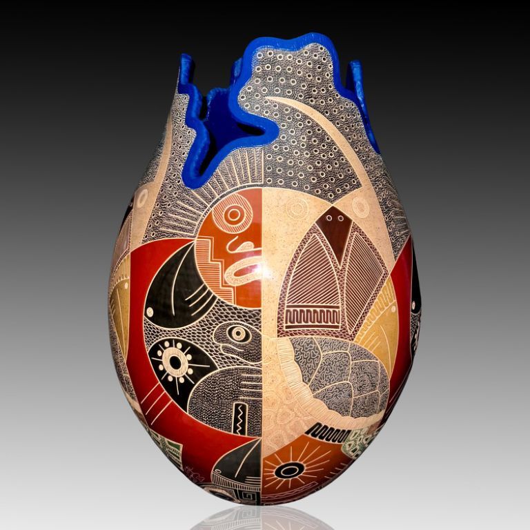 The blue top representing the tales under the sea life. The communication between the humans and the nature. The sun around all. The magnificent owl with the intelligent turtles  the birds and the fishes creating a most resistant team preserving the rooths since the begining of the creation.