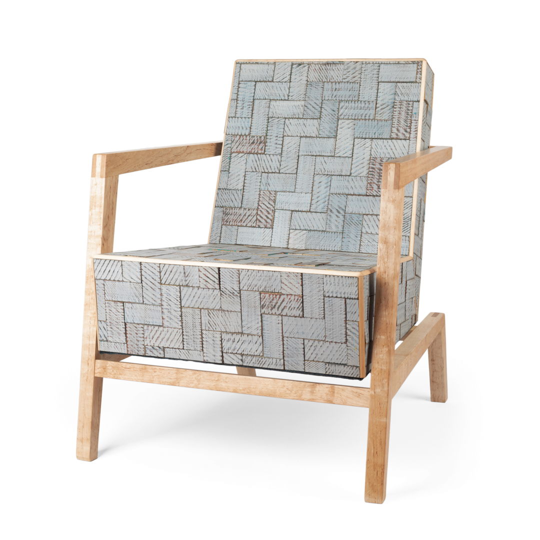 Easy chair with a cantilever frame construction made from maple wood. The "upholstery" is made up of scrap wood tiles that have been textured  painted with several colors of milk paint and have then been sanded for a distressed look. These are mounted to a hollow form box of baltic birch