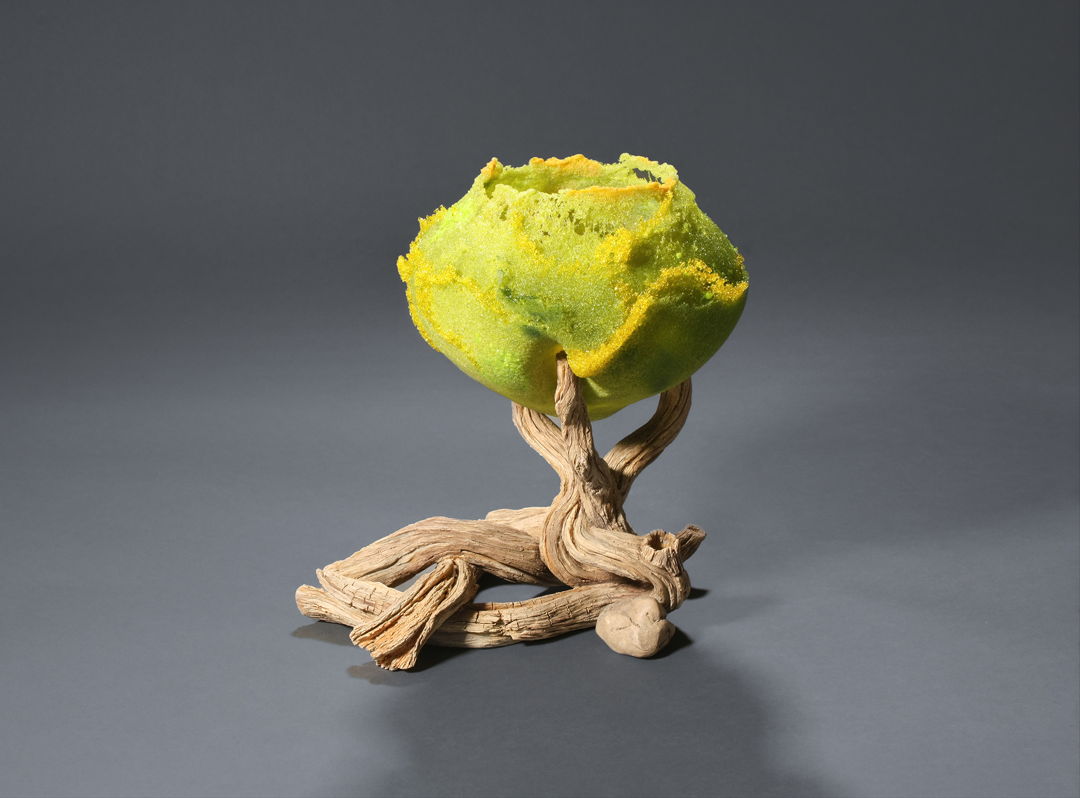 Hand-carved ceramic fired in oxidation with stains and oxides to 2124° F. Cast pate de verre (glass).