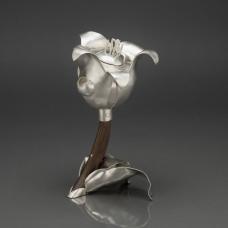 A fully function sterling silver teapot inspired by the form of a tulip. The piece was hand fabricated from flat sheets of silver. Each tulip pedal was hammered and curved to create the form. Fitting all of the pieces together was like building a 3D silver jigsaw puzzle. The handle is carved walnut.