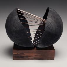 wood orb sculpture two halves joined by metal wires