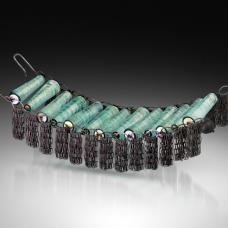 Bracelet made from glass beads hand-formed in the flame using dichroic glass. Frame made from oxidized sterling silver  acetate  with hammered silver closure.