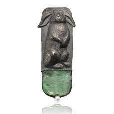 This standing lop earned rabbit is sculpted in silver. It is on top od hiddenite crystal which represent grass.