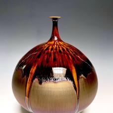 High fire porcelain. Applied the gold and brown glazes. The two-glaze run and made the design naturally.