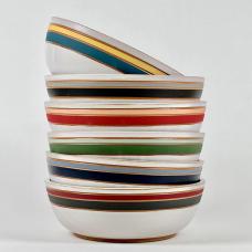 Wheel-thrown stoneware dinner bowls with satin white glaze and colorful carved underglaze stripes.