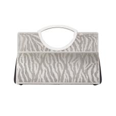 The zebra tote is hand fabricated in etched stainless steel with leather gussets  double handles and a spring hinge closure.
