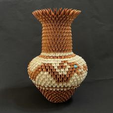 Water serpent vessel constructed out of metallic brown and handmade ivory paper. The water serpent design is prevalent in many Pueblo pottery designs  most notably San Ildefonso pottery  but Acoma Pueblo also has its own oral stories about water serpents. The inlaid turquoise eye is natural sleeping beauty turquoise