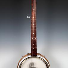 The image on the head of the banjo is a hand-cut linoleum block printed onto the inside surface.