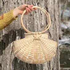Modern melon basket with strong geometric elements. White oak frame, woven with ash. White oak handles.