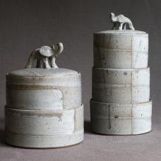 Wheel-thrown jars  precisely sized to form tidy stacks. Hand-sculpted elephant figurines as lid handles. Glazed and fired to cone 6.