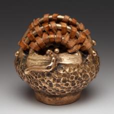 One of a kind lost wax cast bronze and woven Black Willow bark basket.
