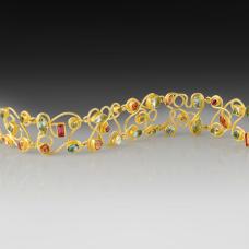 Mixed cut and shape aquamarines and pink tourmalines (14.45ct total) set in 22k gold bezels with 18k backing  swirl design and safety clasp.