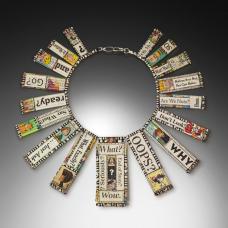 Recycled Newspaper Comic Strips and various news headlines are hand-formed into beads and hand-strung together into the form of a neckpiece.
