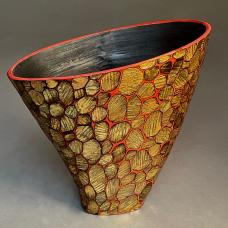 This hand carved wood bowl has a surface that has been gilded with oxidized metal leaf.