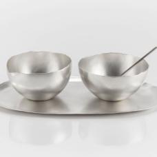 A sugar  creamer  tray  and spoon set. The creamer has a subtle spout included in the form