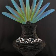 Black and white matte paper  blue and gold macaw feathers. Over 6 500 individually folded paper modules were used to create this piece  including micro origami pieces on the lid. Vessel took 3 months to complete