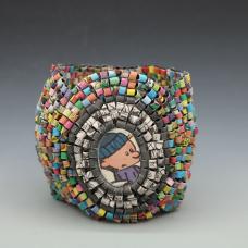 Bracelet consisting of recycled newspaper colorful comic strips and recycled newspaper black and white comic strips which are hand-formed into beads and stitched together on elastic cord.