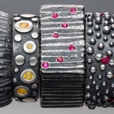 Oxidized Sterling silver rings of different textures with sapphires and rubies