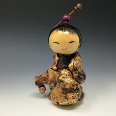 Kokeshi made from Buck Eye burl  Maple  Tulip Poplar and Rosewood holding the lantern that shows the way.
