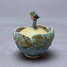Wheel thrown porcelain altered  bird hand sculpted. Layered glazes fired to cone 7 in electric kiln.