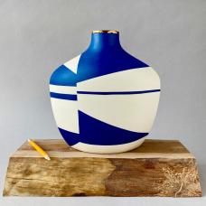 Made from thin slabs of pigmented porcelain fitted together and sanded  backed with white porcelain  cone 7 fired; additional 22k gold luster firing. Surface shows abstract imagery of locations and narratives intimate to me.