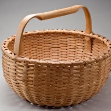Hand crafted of brown ash splint. Pounded  hand scraped  woven. The handles and rims are hand split  carved  and green bent.