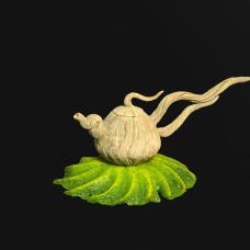 Hand carved ceramic teapot on cast glass base