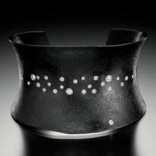 Hand-forged iron cuff with diamond sprinkle set in platinum. 18k gold name plate on inside.