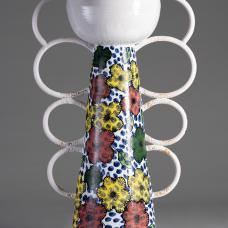 vertical sculpture with orb at top and circles lining either side